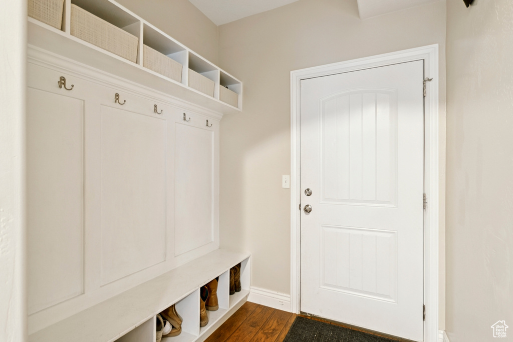 Mudroom featuring baseboards and dark wood-style flooring