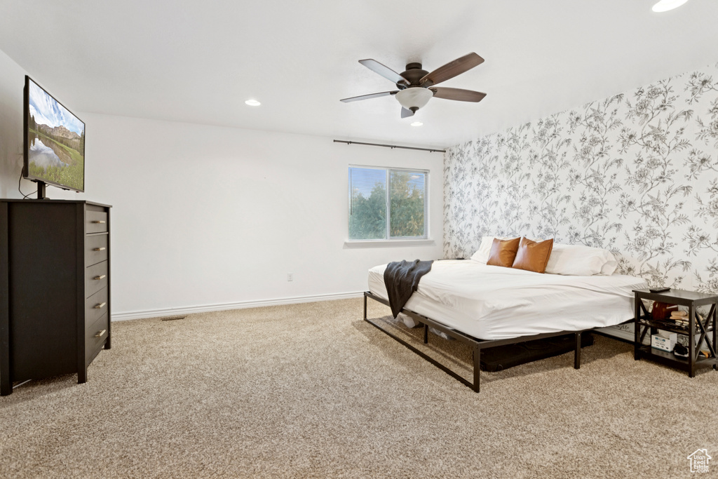 Bedroom with wallpapered walls, recessed lighting, light carpet, and a ceiling fan