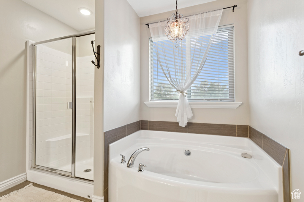 Bathroom featuring a garden tub and a stall shower