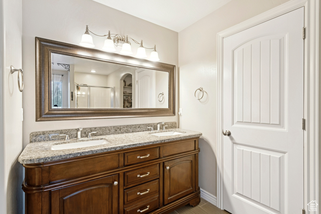 Bathroom with double vanity and a stall shower