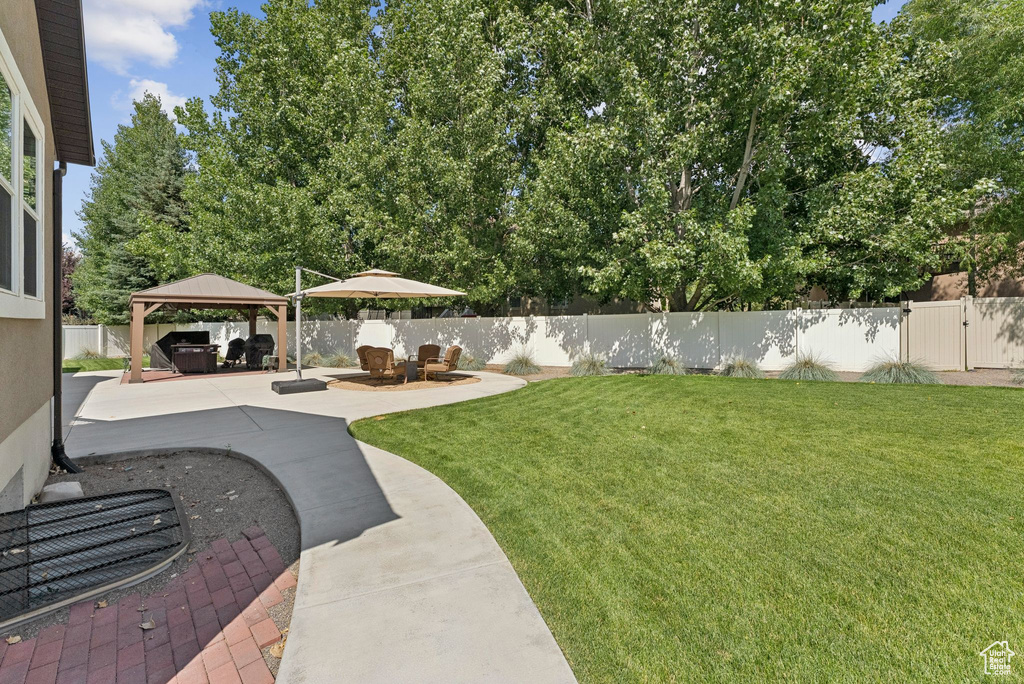 Fenced backyard with a gazebo and a patio area