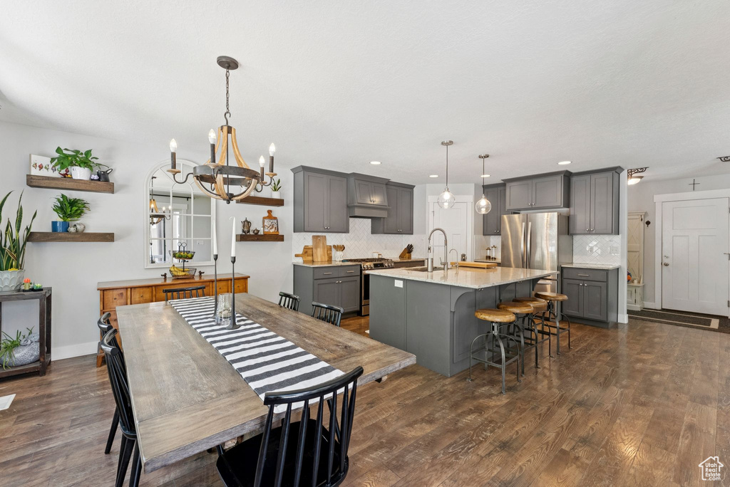 Dining space featuring a chandelier, dark wood-style flooring, and recessed lighting