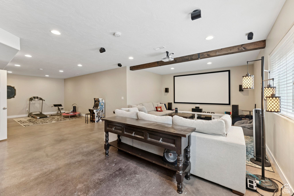 Cinema room with recessed lighting and finished concrete floors
