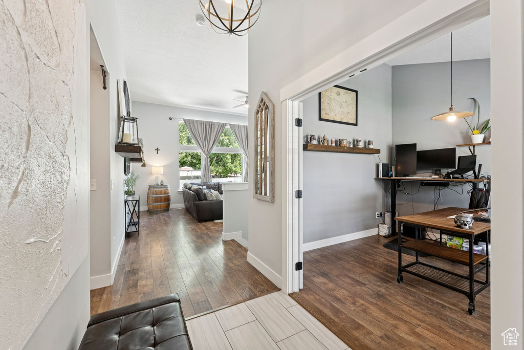 Foyer entrance featuring wood finished floors and a chandelier