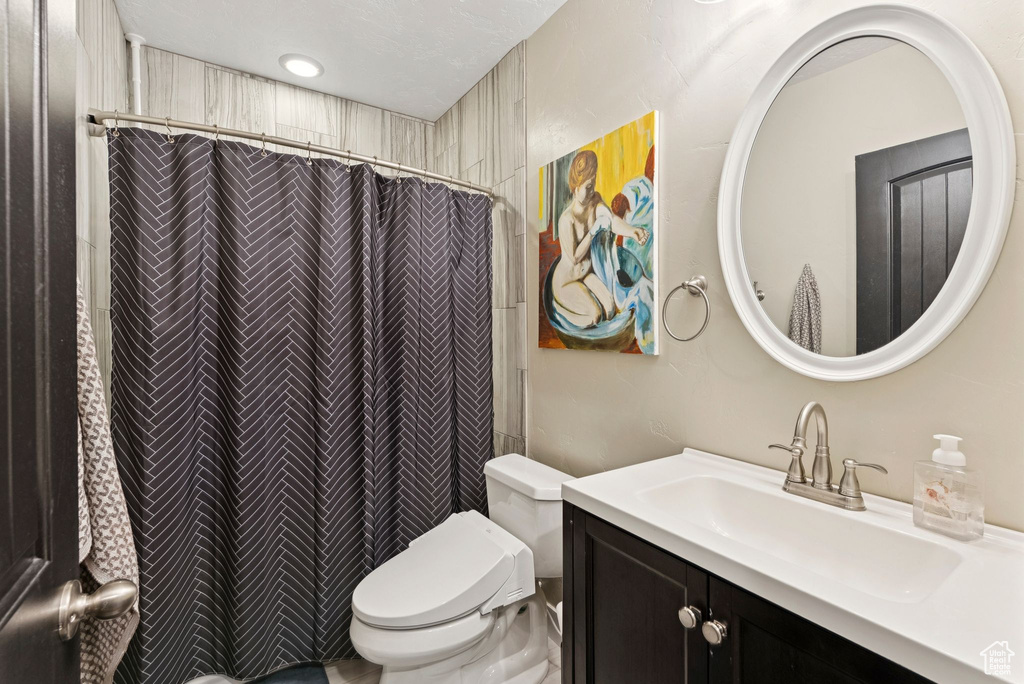 Bathroom featuring vanity and curtained shower
