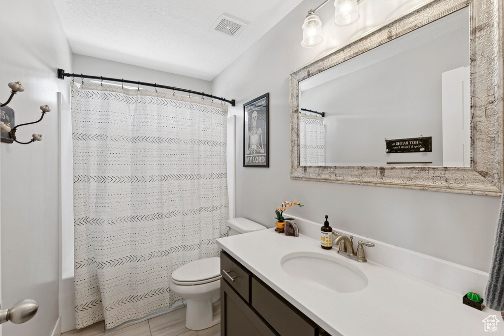 Full bathroom featuring vanity and curtained shower