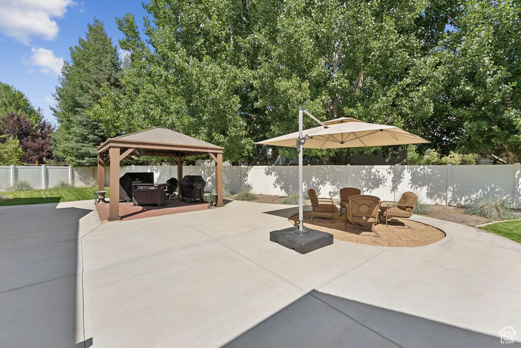 Fenced backyard with a patio area and a gazebo