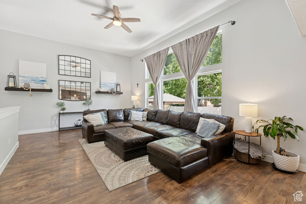 Living room with ceiling fan and hardwood / wood-style flooring