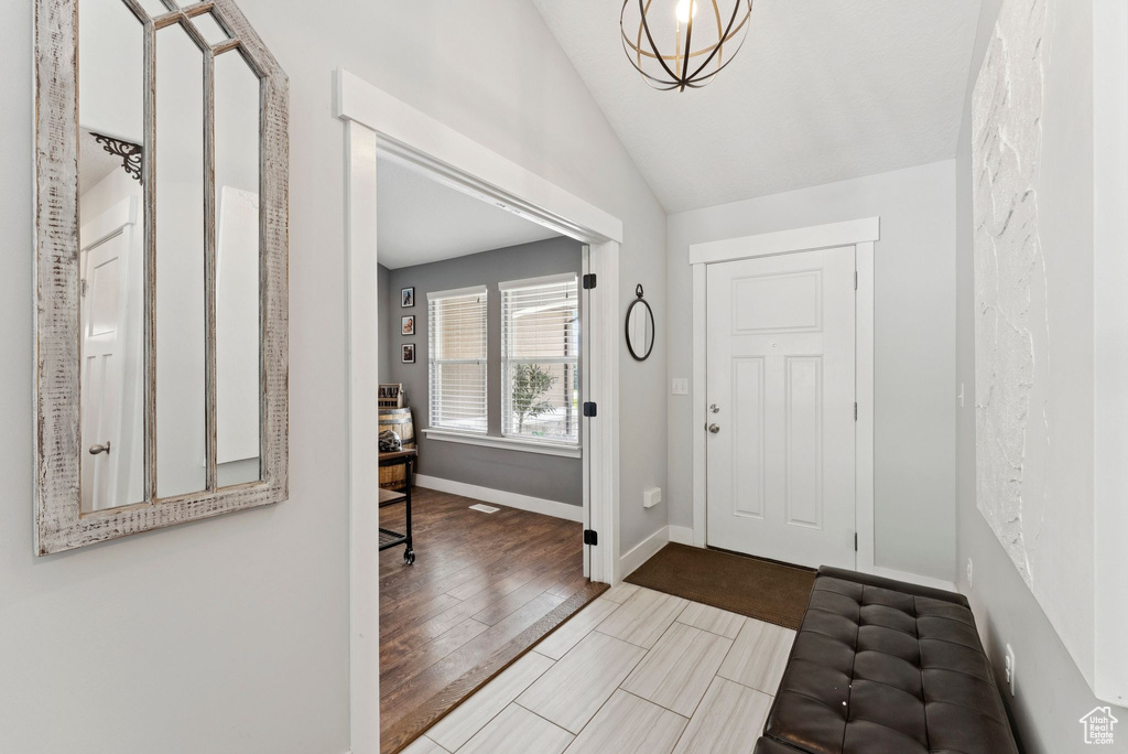 Entryway with lofted ceiling and baseboards