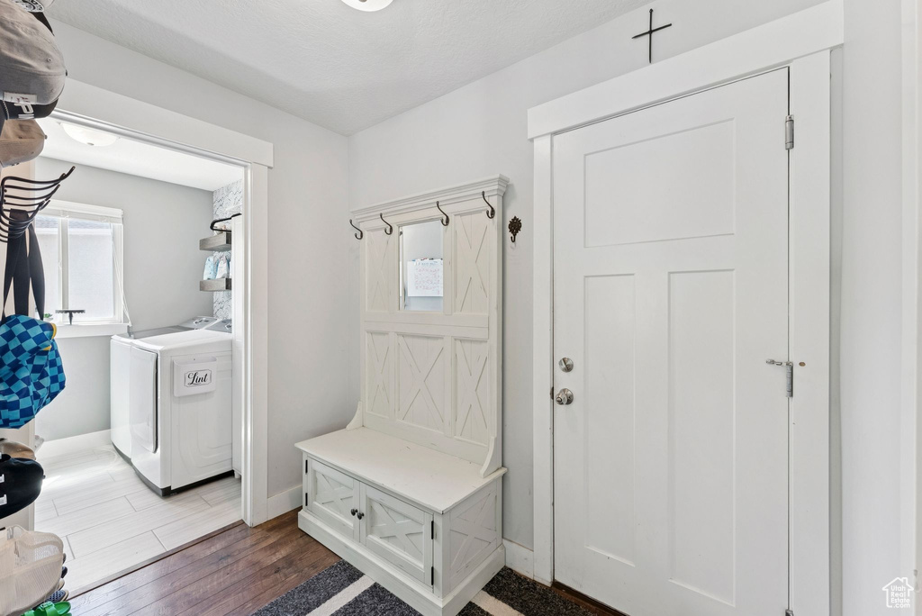 Mudroom with washer and dryer and wood finished floors