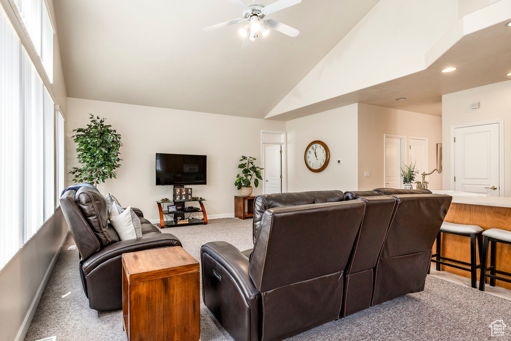 Living room featuring high vaulted ceiling, carpet floors, ceiling fan, healthy amount of natural light, and recessed lighting
