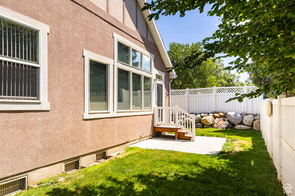 Fenced backyard with a patio