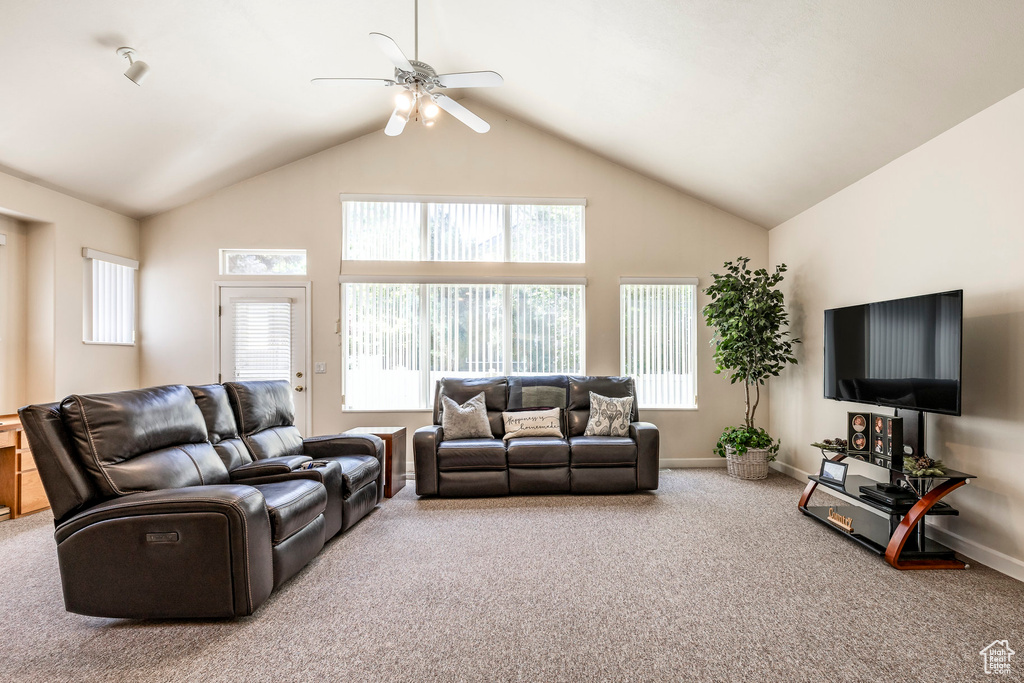 Living room featuring carpet, a ceiling fan, healthy amount of natural light, and high vaulted ceiling