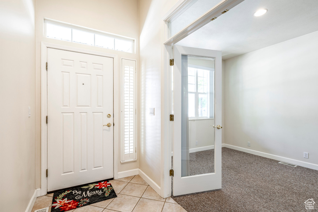 Foyer entrance featuring baseboards and light tile patterned floors