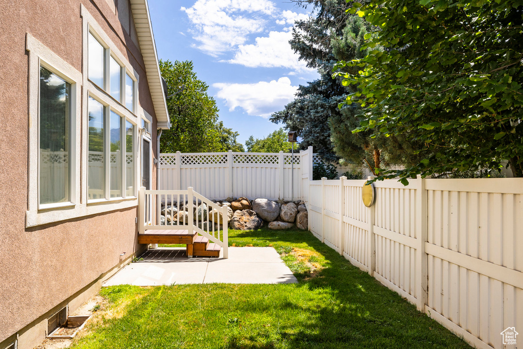 Fenced backyard with a patio