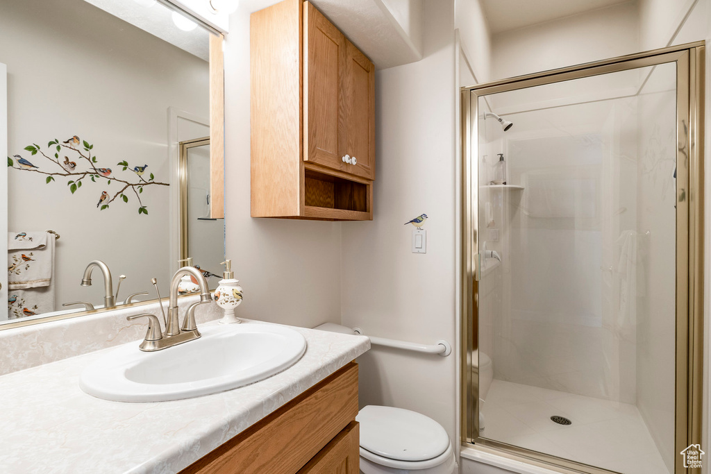 Full bathroom with vanity and a stall shower