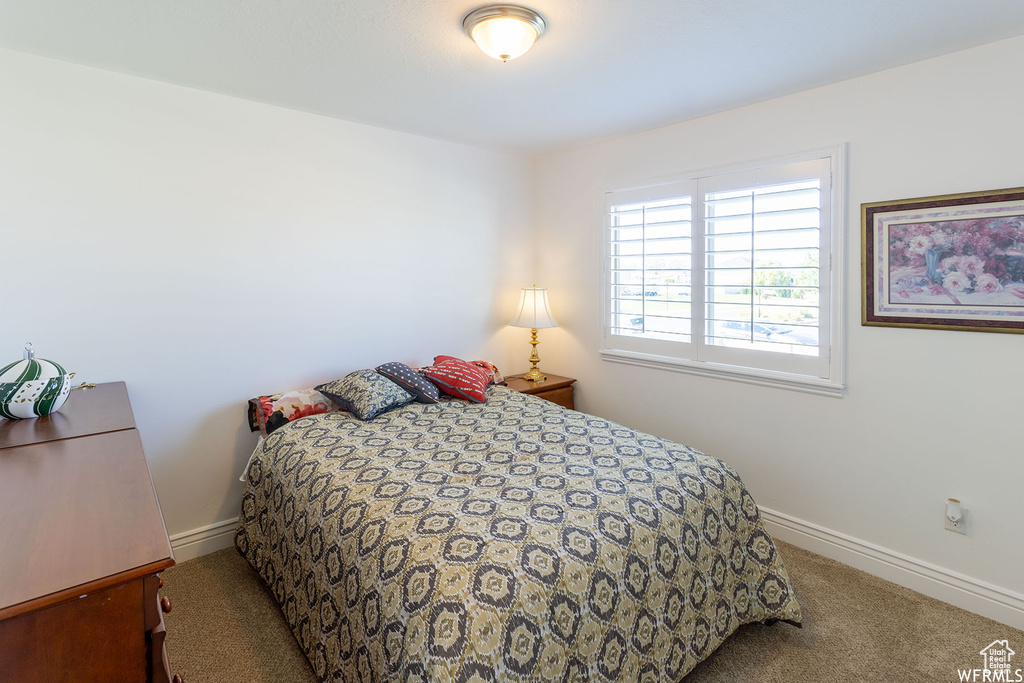 Bedroom featuring baseboards and carpet flooring