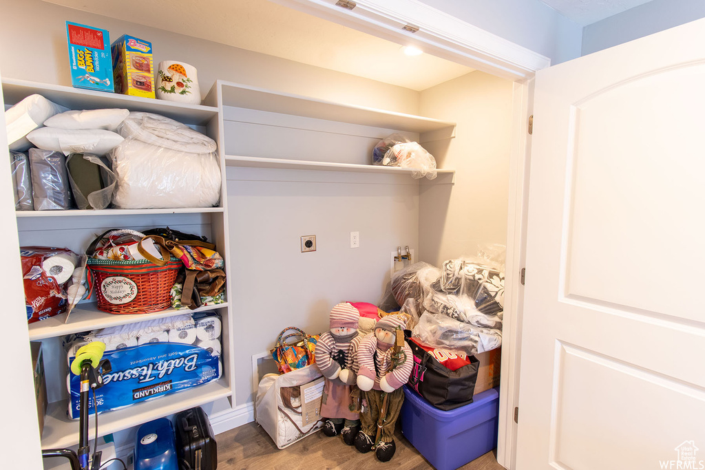 Laundry room featuring hookup for an electric dryer and wood finished floors
