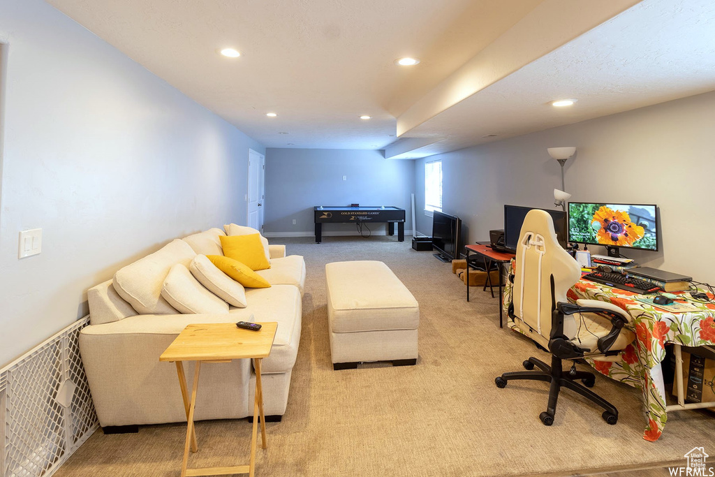 Carpeted office space with recessed lighting and billiards table