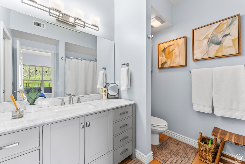 Bathroom featuring vanity and wood finished floors