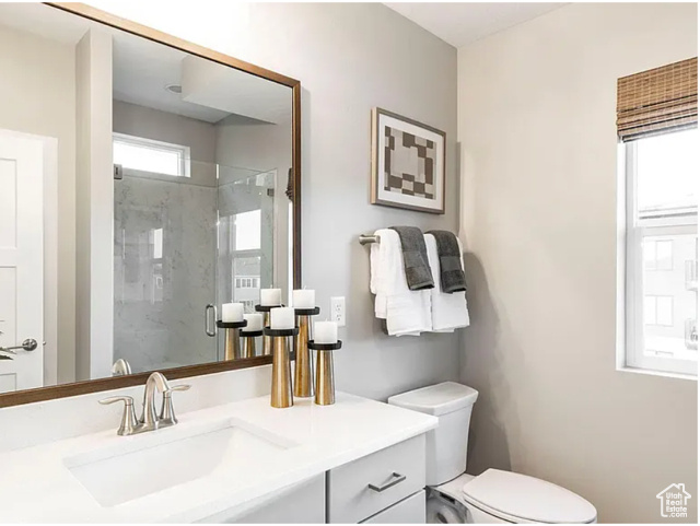 Full bathroom with a marble finish shower and vanity