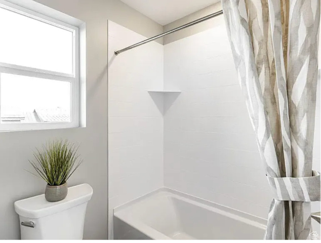 Full bath with toilet and shower / bath combo
