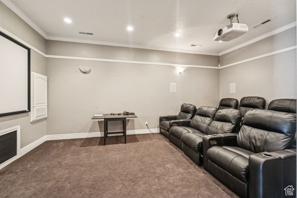 Cinema room with carpet floors, crown molding, and recessed lighting