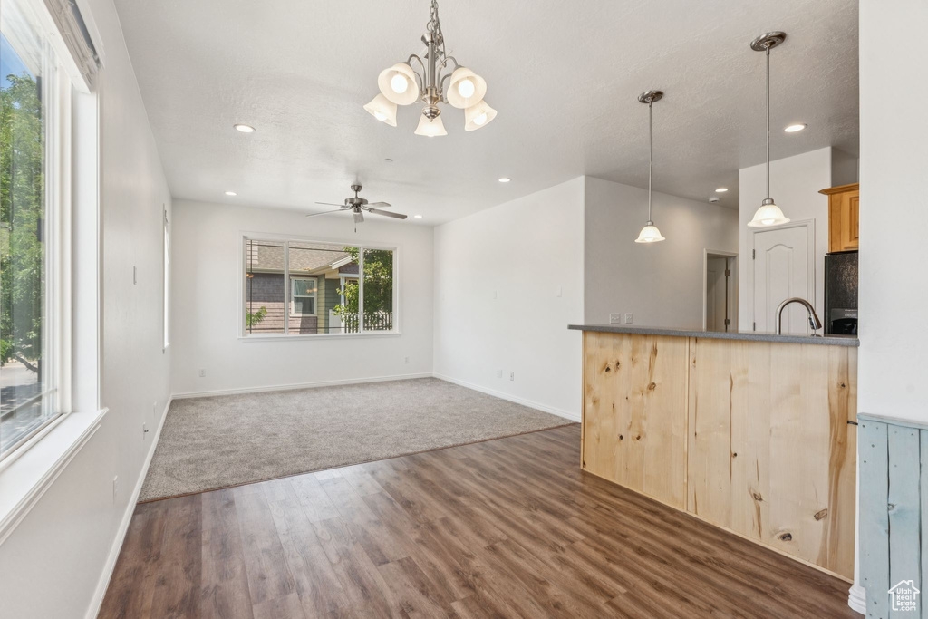 Kitchen featuring refrigerator, a chandelier, dark wood-style flooring, recessed lighting, and ceiling fan