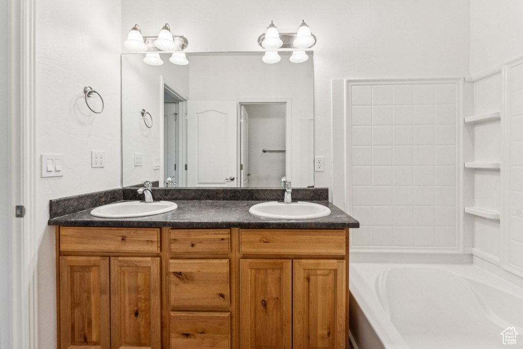 Bathroom with double vanity and a bathtub