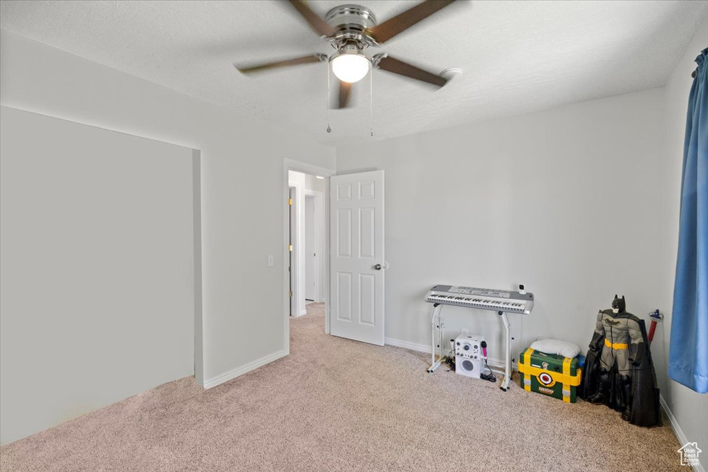 Recreation room featuring carpet floors and ceiling fan