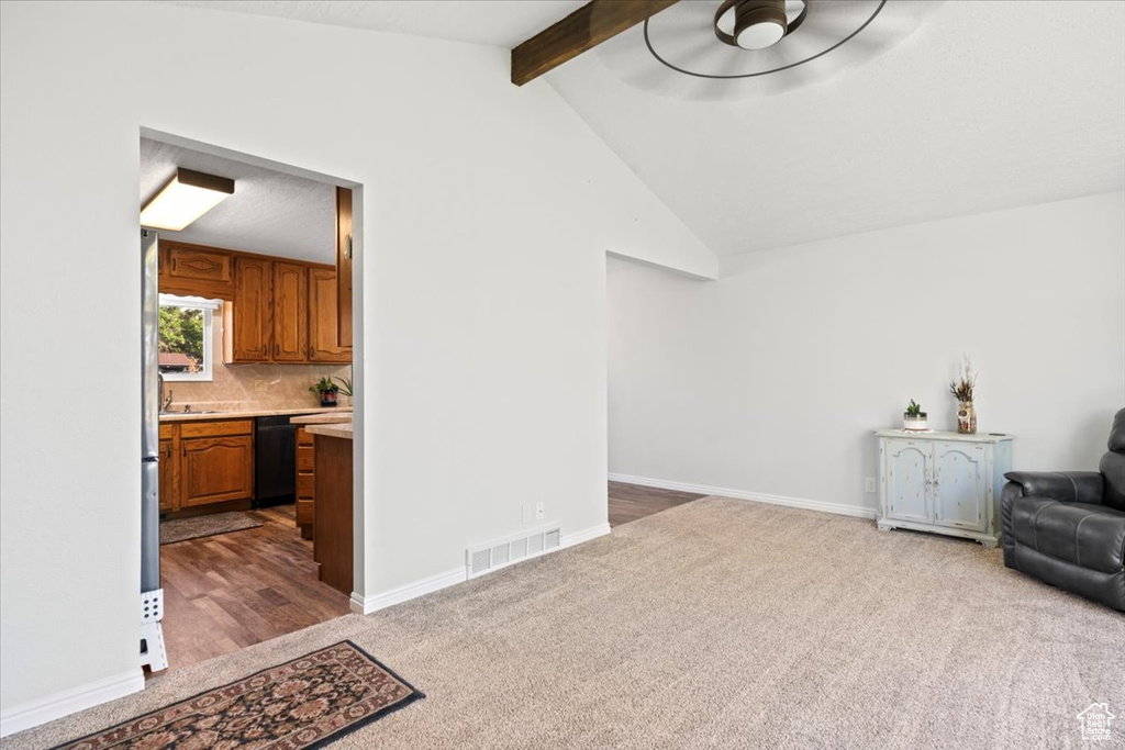 Unfurnished room featuring dark carpet and baseboards