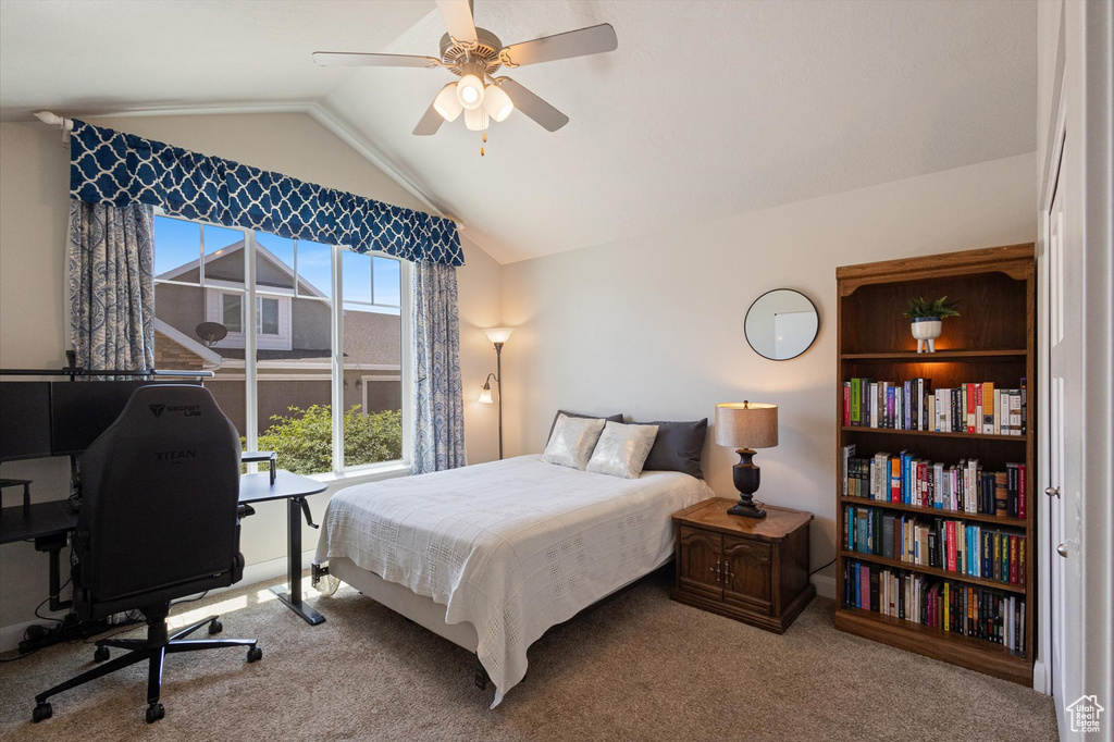 Bedroom with lofted ceiling, carpet floors, a desk, and ceiling fan
