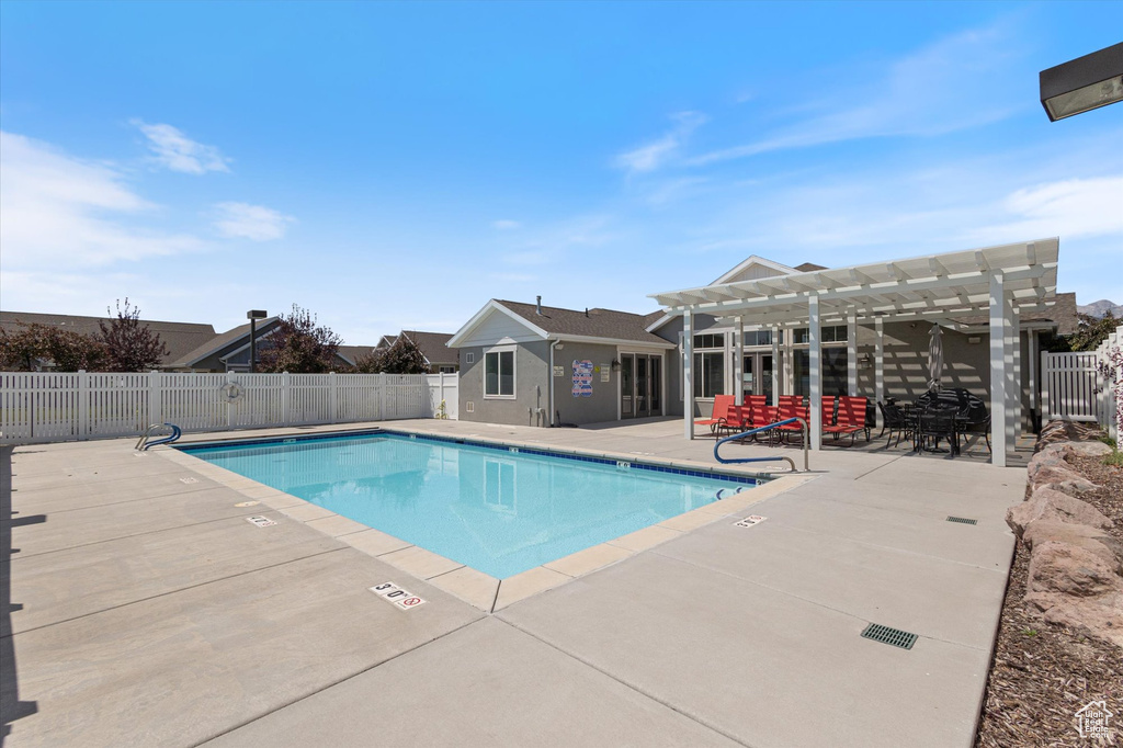 Community pool with a pergola and a patio