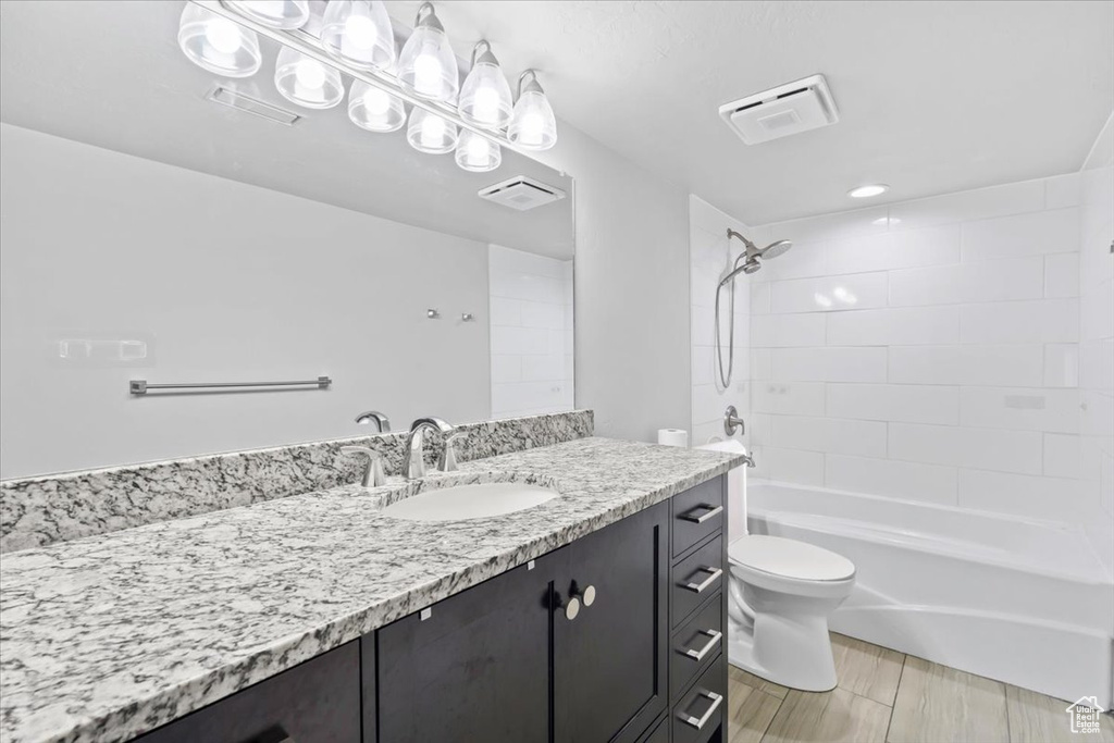 Full bathroom with vanity and washtub / shower combination