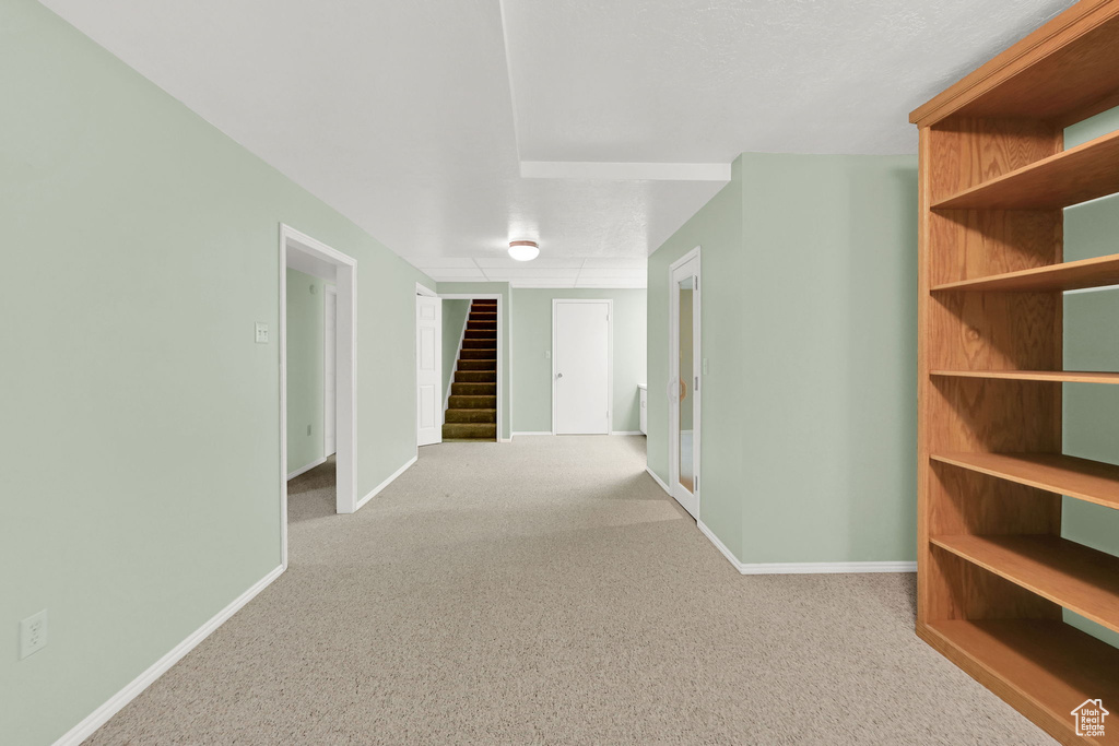 Corridor with carpet floors and stairway