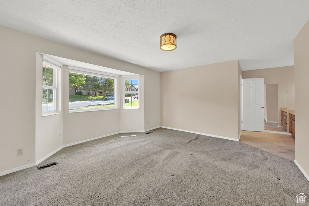 Carpeted empty room with baseboards
