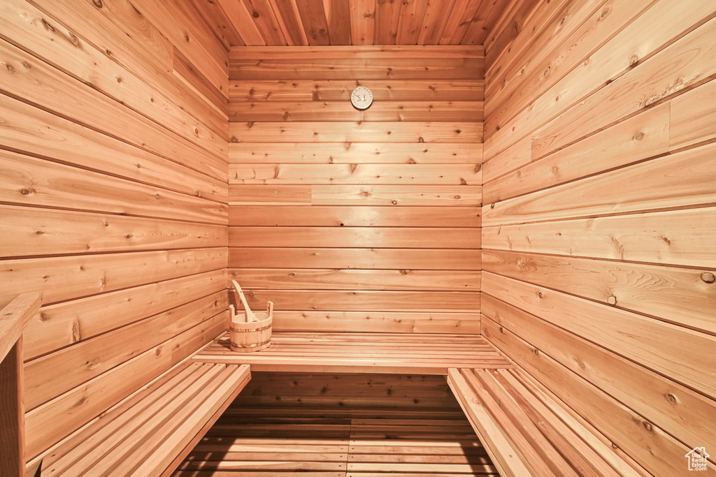 Relaxing sauna / steam room featuring wooden walls and wooden ceiling