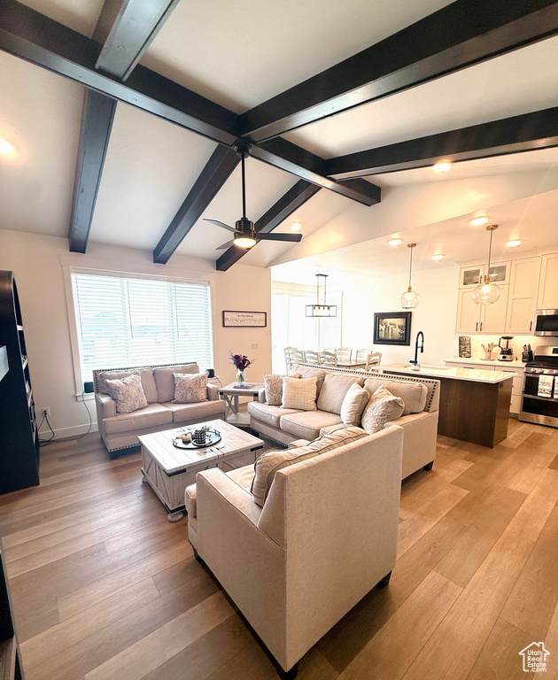 Living room featuring light wood-style flooring, ceiling fan, and recessed lighting