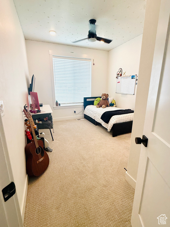 Carpeted bedroom with baseboards and ceiling fan