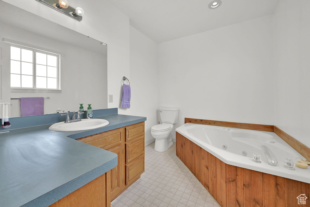 Full bathroom featuring vanity and a tub with jets