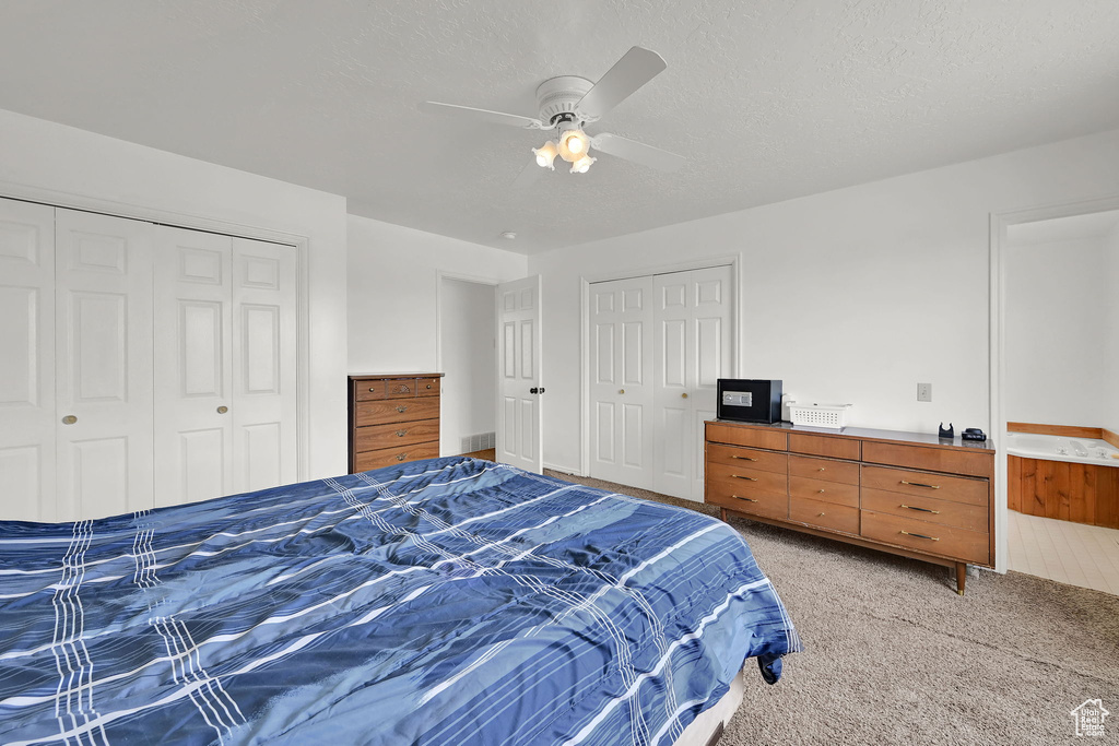 Bedroom featuring light carpet and ceiling fan