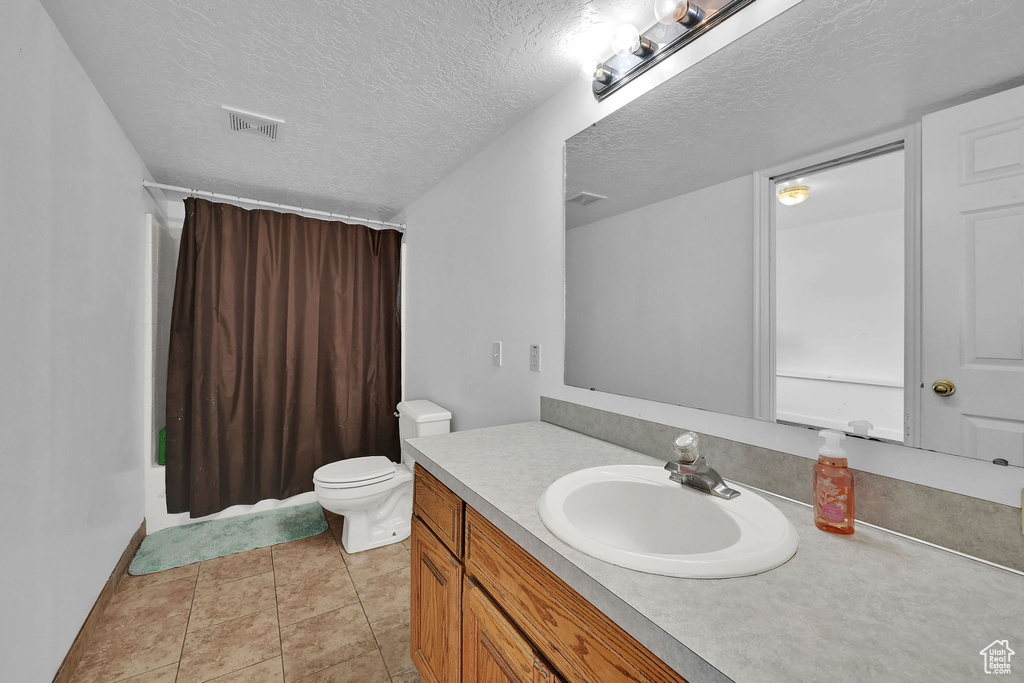 Bathroom featuring vanity and a textured ceiling