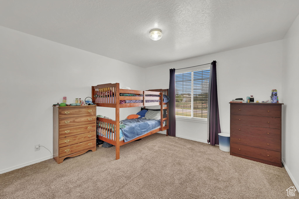Bedroom with carpet flooring and a textured ceiling