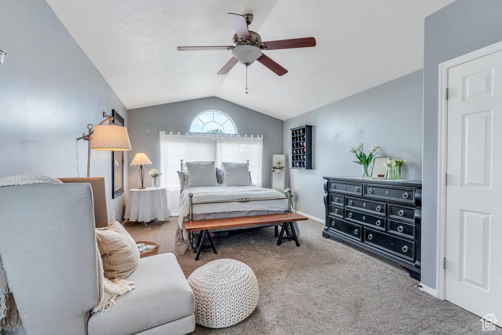 Bedroom with carpet flooring, vaulted ceiling, and ceiling fan