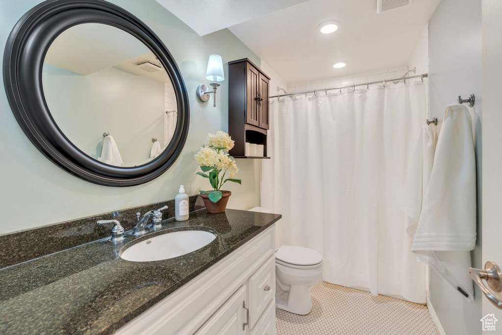 Bathroom featuring vanity, tile patterned floors, a shower with curtain, and recessed lighting