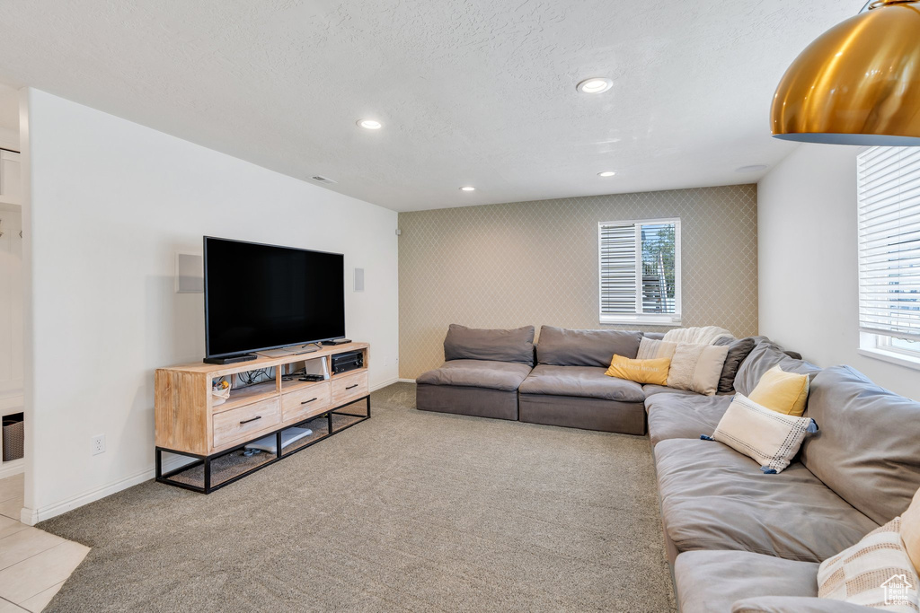 Carpeted living room with baseboards and recessed lighting
