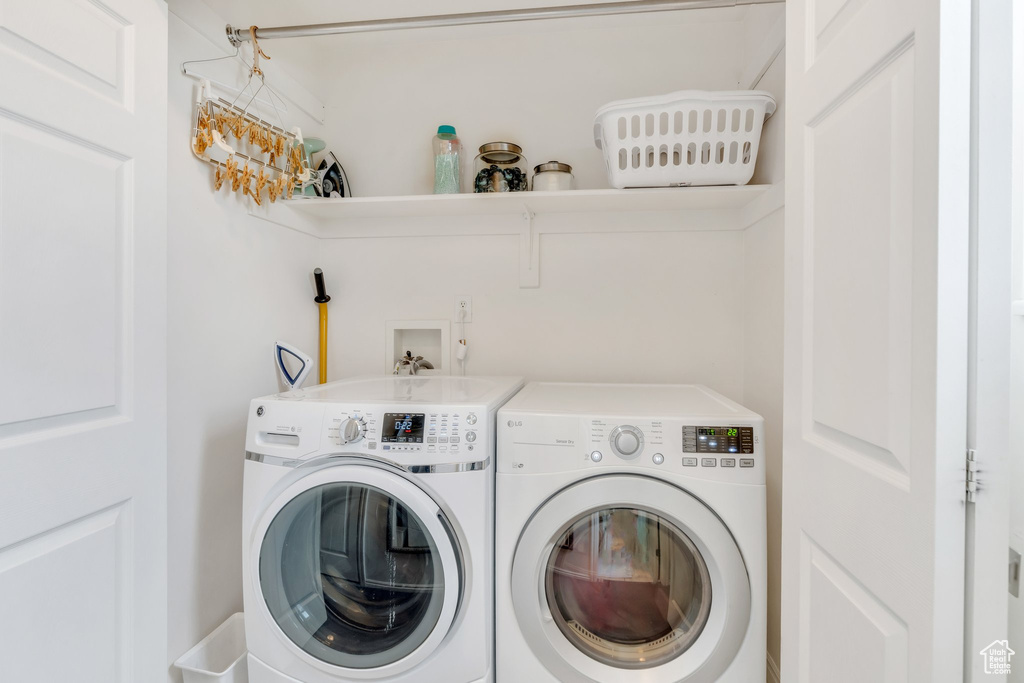 Laundry room with washer and clothes dryer