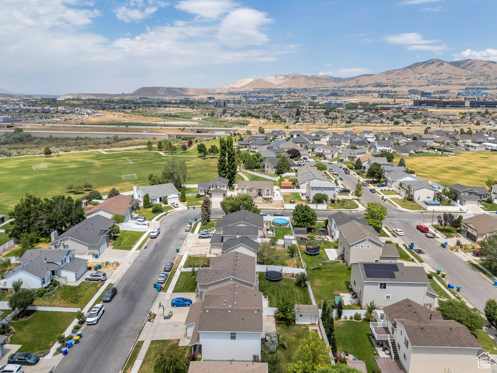 Aerial view of property\'s location featuring nearby suburban area and a mountain backdrop