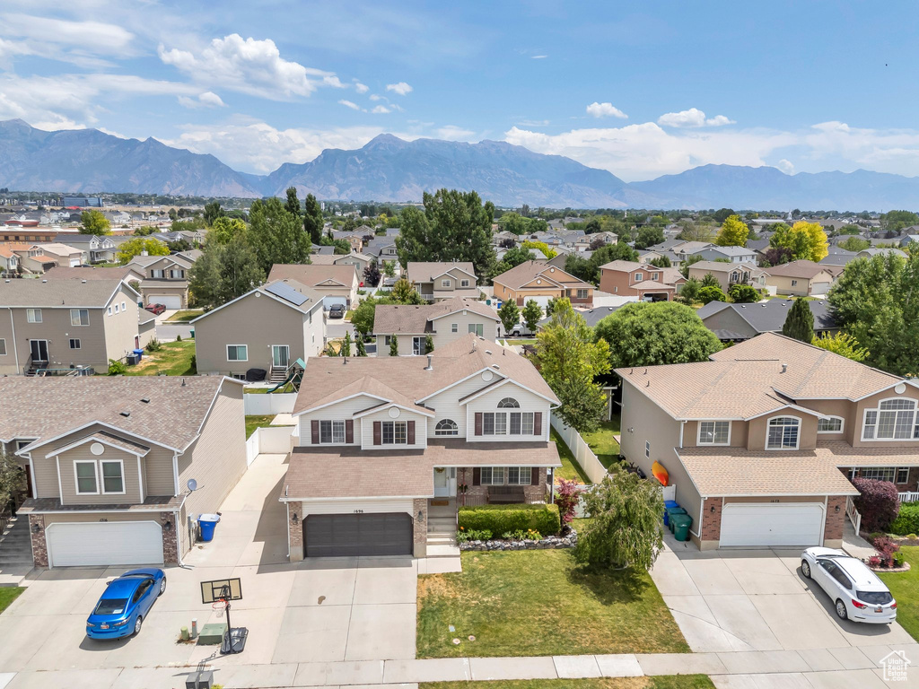 Aerial view of residential area featuring a mountainous background