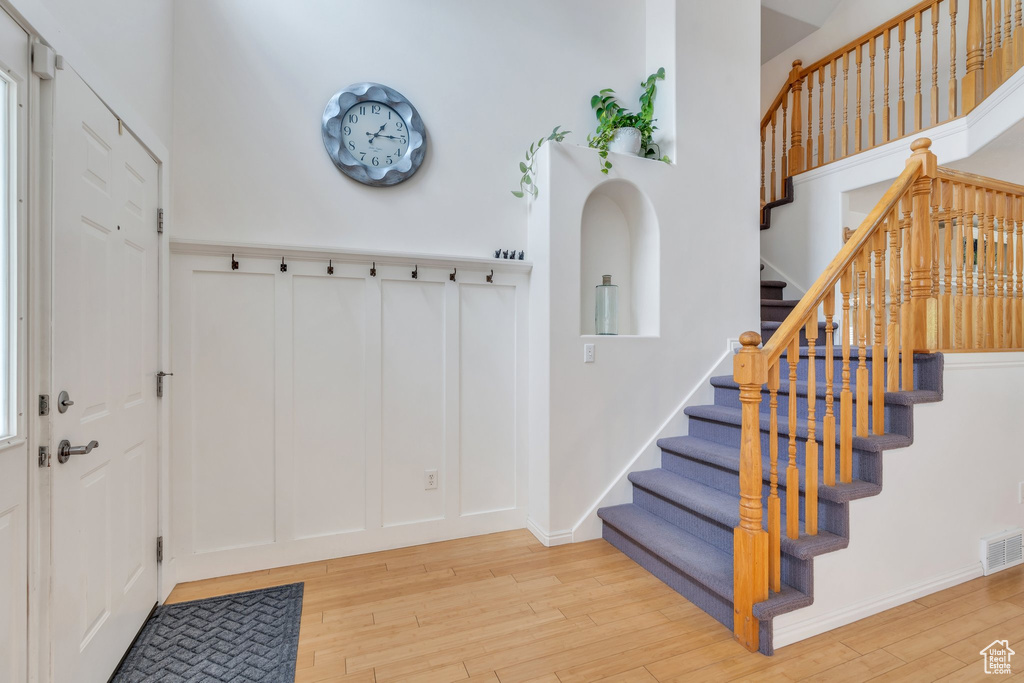 Foyer entrance featuring wood finished floors and stairway
